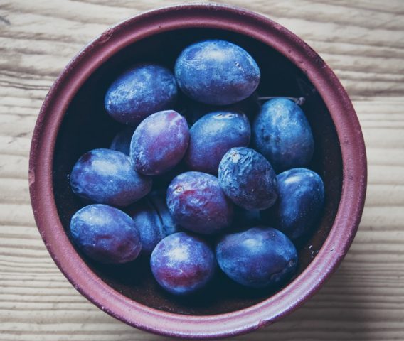 Latest Sale interior design, plums, purple bowl on wooden surface