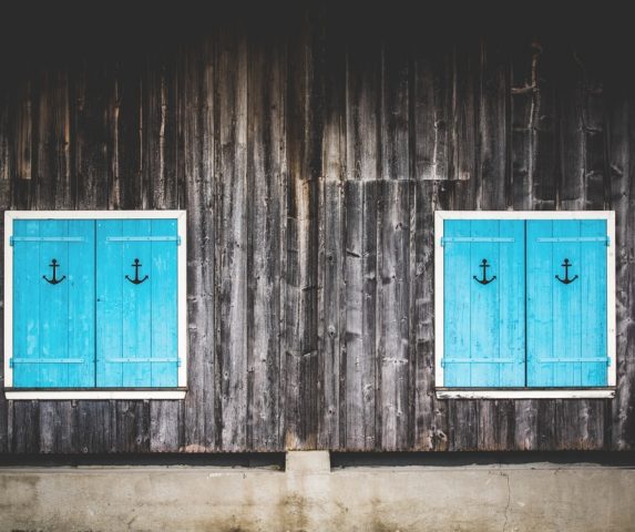 Latest Sale Interiors, Grey wooden panels with Turquoise window frame